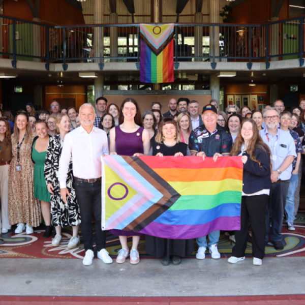 Group of people with pride flag at Wollotuka