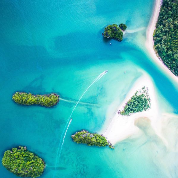 Aerial shot of crystal clear water in the Pacific ocean. Collaborating for clean energy and coastal resilience in the Pacific