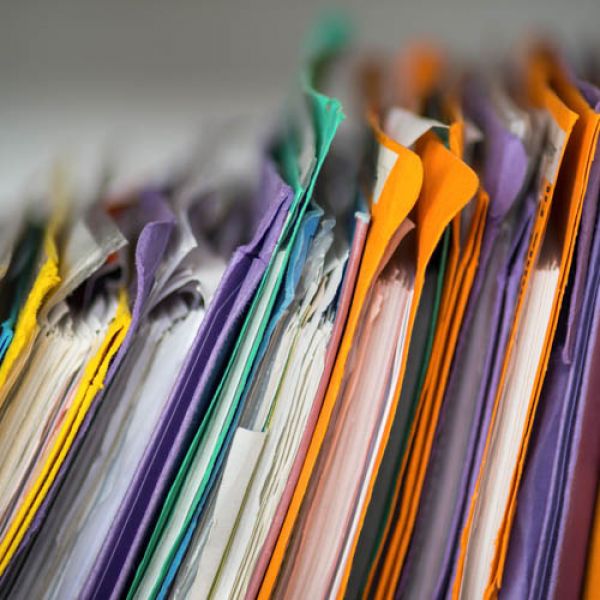 A stack of files in colourful manilla folders - Case Studies