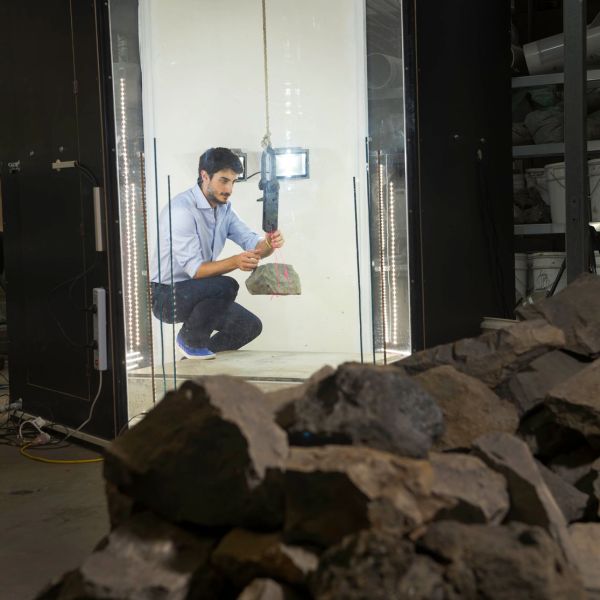 Davide can be seen in a chamber, with equipment holding a rock
