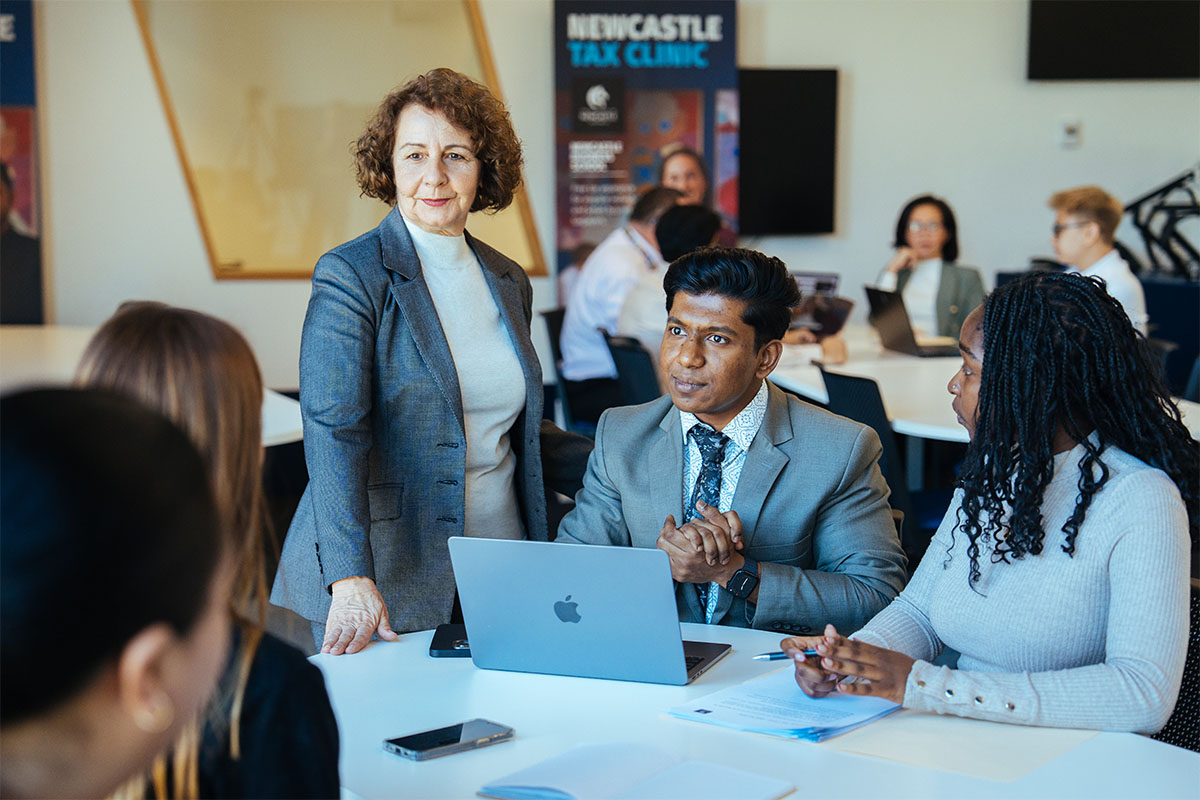 A group of people sitting at a desk