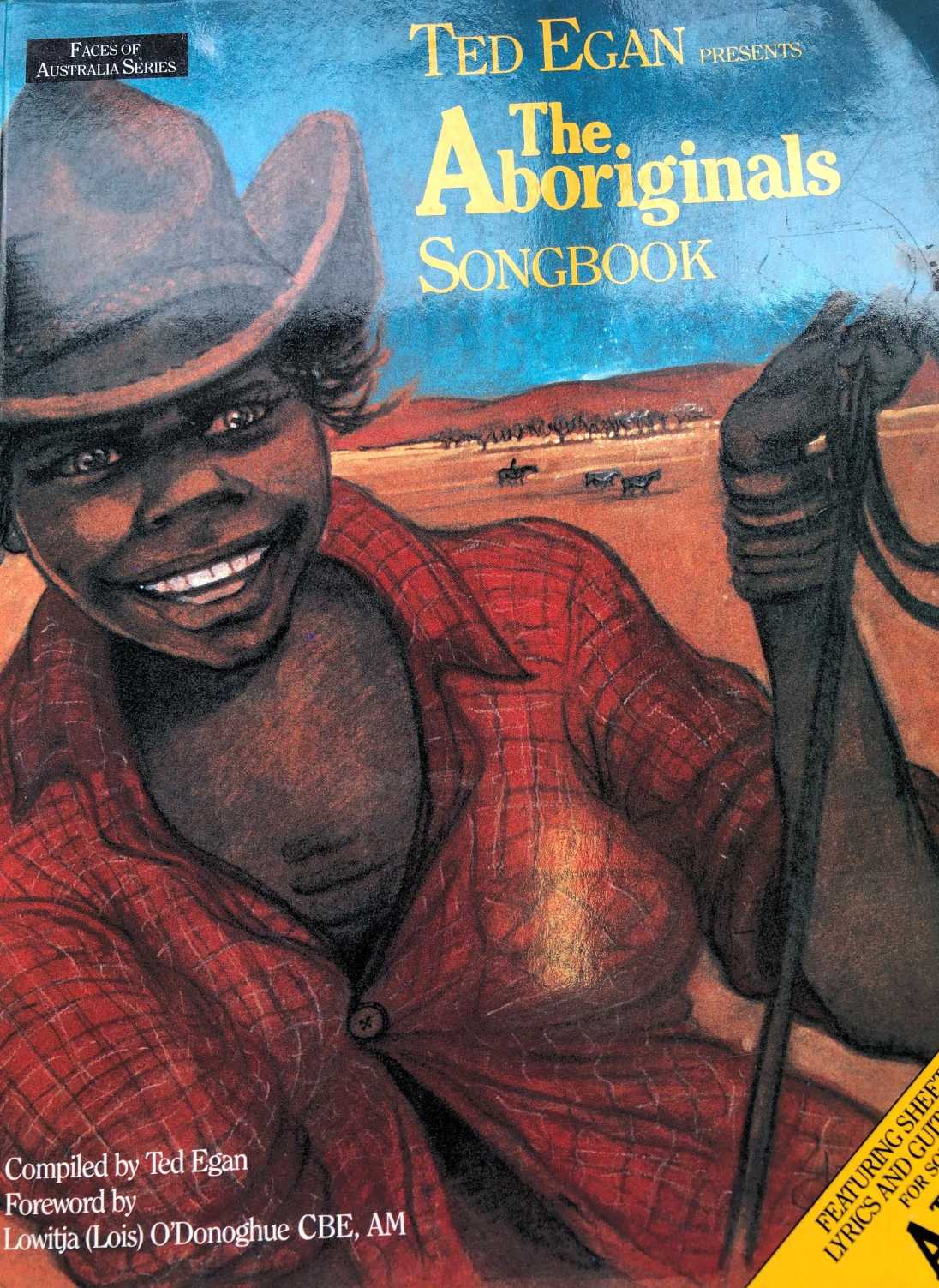 Cover of Ted Egan's songbook A colourful drawing of a young Aboriginal stockman holding a rope. Cattle andred earth make up the background