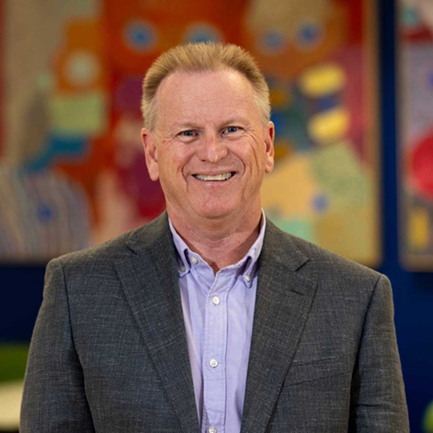 Professor James Skinner pictured looking directly at the camera and smiling.