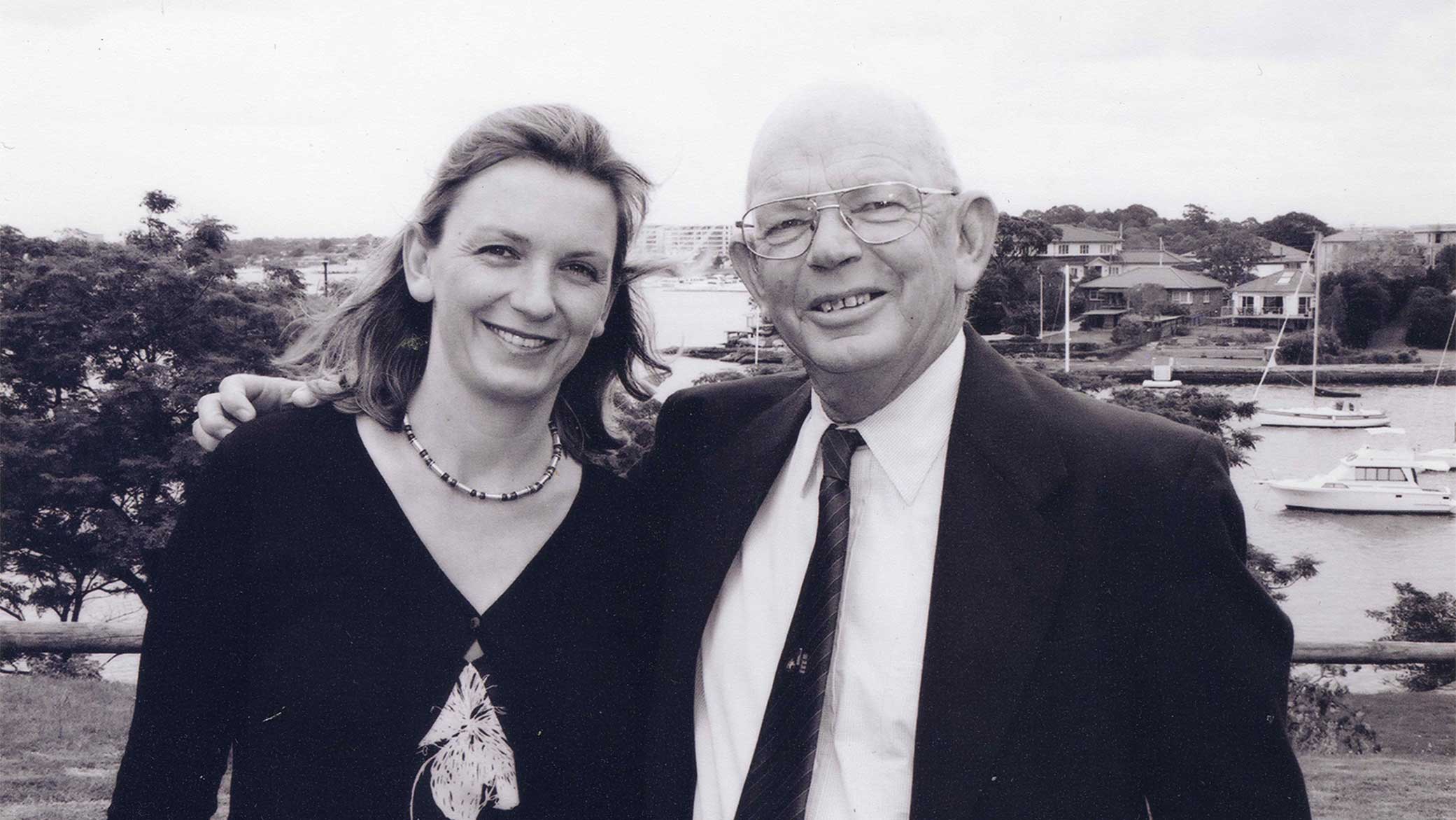 A black and white photo of a woman, Julie-Anne Edwards, standing with her late father, Robert (Bob) Edwards