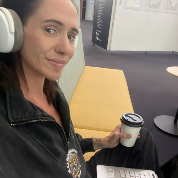 Kat taking a selfie in Ourimbah, with a coffee and her laptop