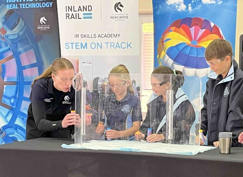 3 students with host launching Alka Seltzer rockets