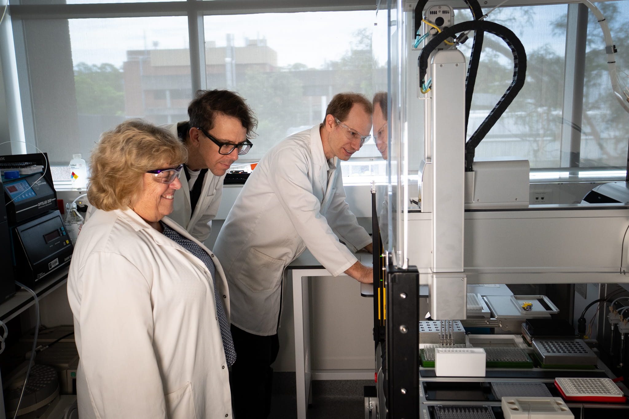 Scientists watch the robot perform a task