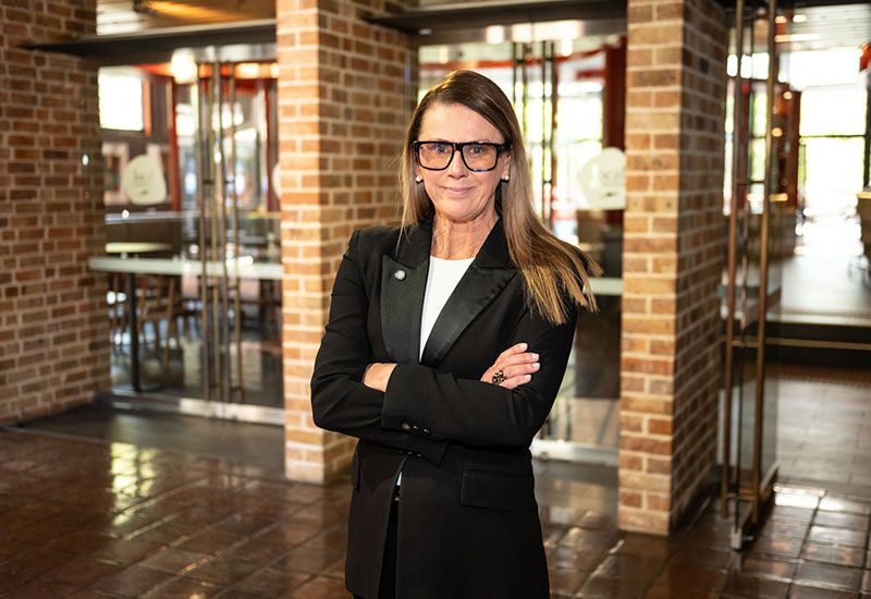 Woman in a suit with her arms crossed