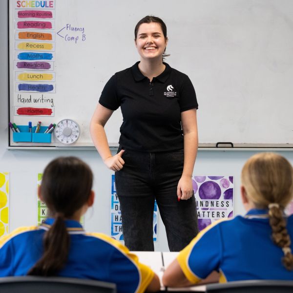 Proud Wiradjuri woman and Education student, Millie Mills, teaching in a classroom. Millie’s pathway to becoming an inspiring teacher and making a change in community.