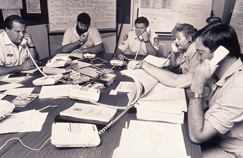 Several people seated at desks answering telephones in an emergency call centre set up in response to the 1989 Newcastle earthquake.