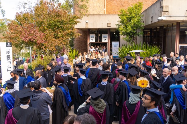 A crowd of graduates at the great hall