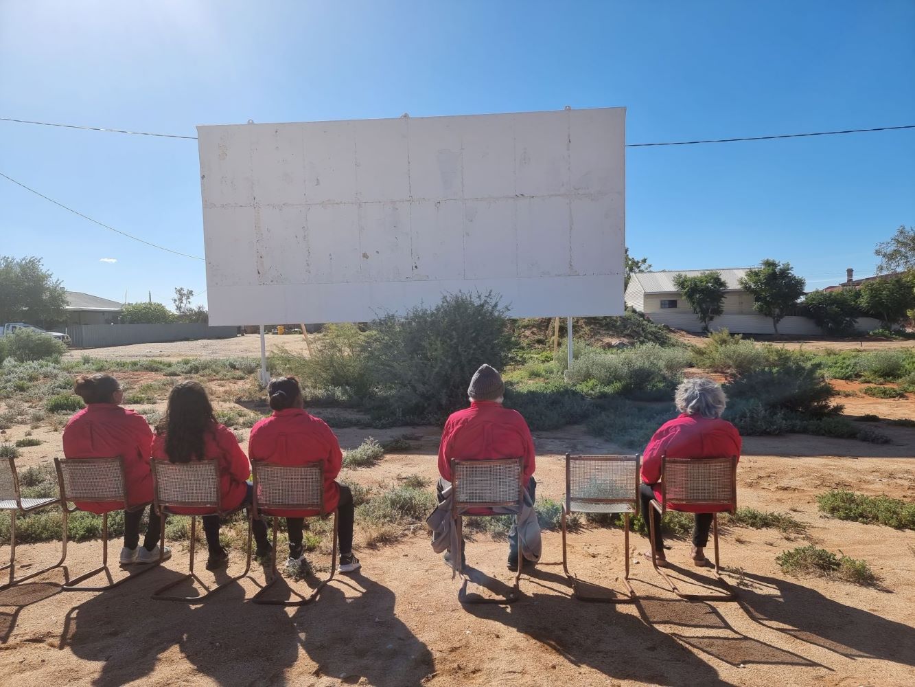 Women sitting in an abandoned outdoor movie place