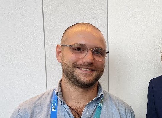 Ed Johnson smiles in front of a plain white background