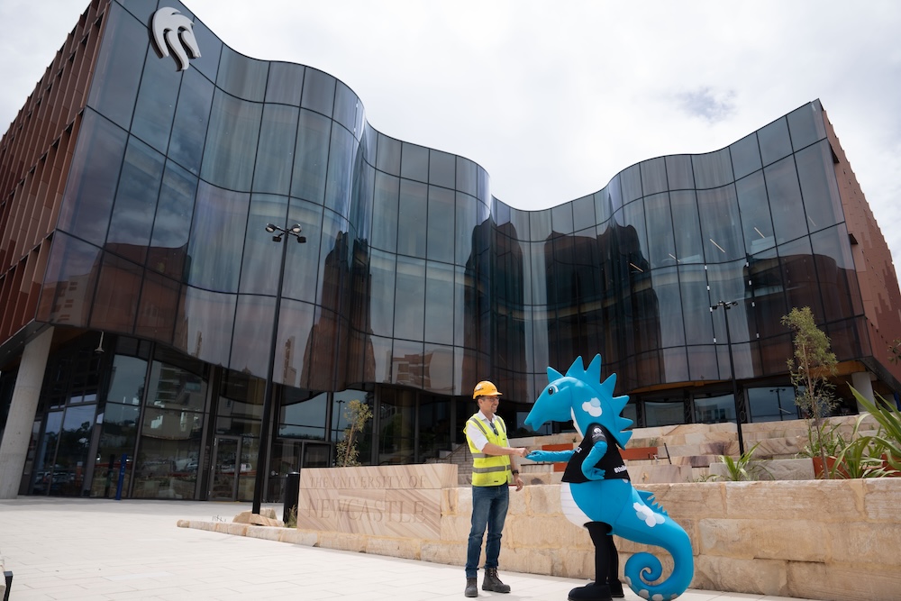 University Mascot, Hunter the Hyppocampus, receives the key to the new Gosford Central building from Hansen Yuncken contractor Robert Schmitzer.