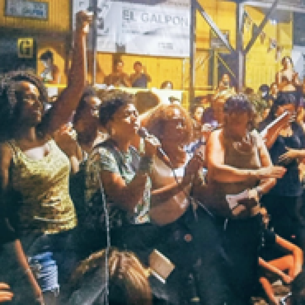 A large group of women singing and listening