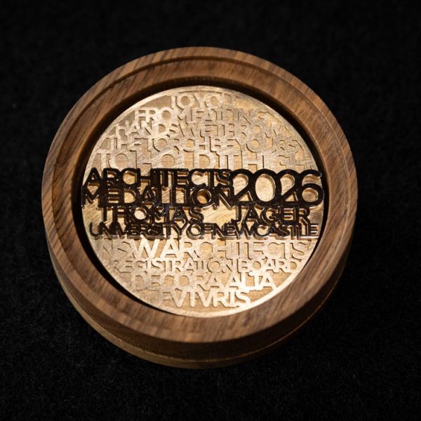 A gold-coloured medallion with winner Thomas Jager's name on it, and the year 2026, in addition to other wording.. Master of Architecture Graduate named top in state with 2026 Architects Medallion.