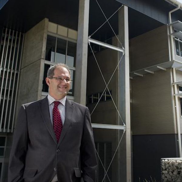Alan Broadfoot Alan Broadfoot smiling in front of NIER building