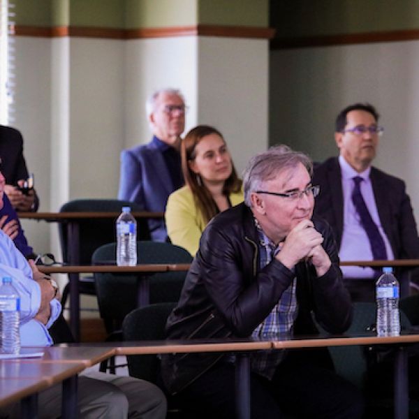 Audience members listening to presentations