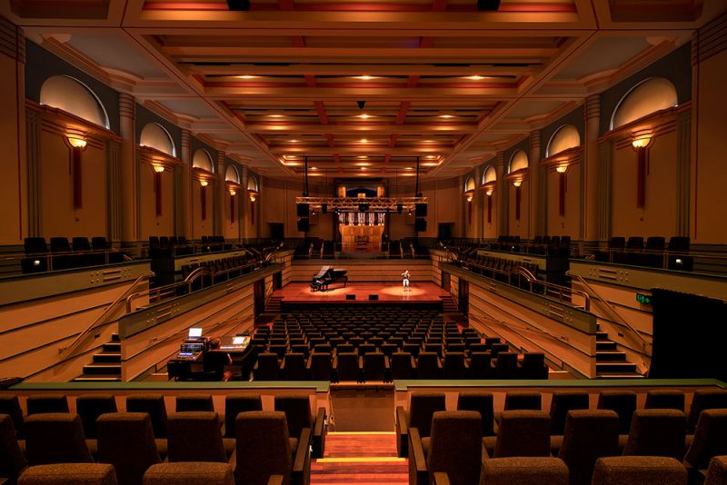 View of concert hall auditorium, red seats and stage lights