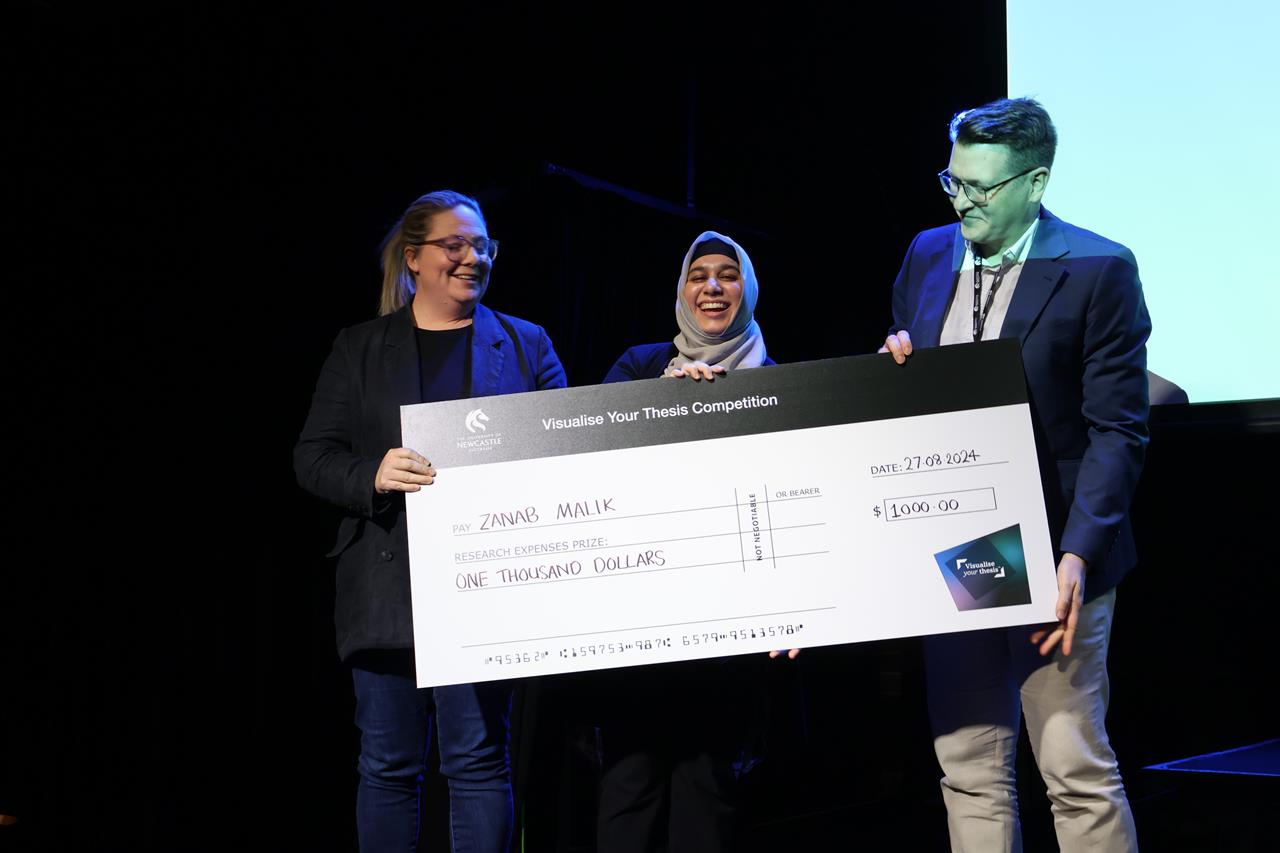 Zanab Malik accepting the first place cheque from the judges of the VYT competition