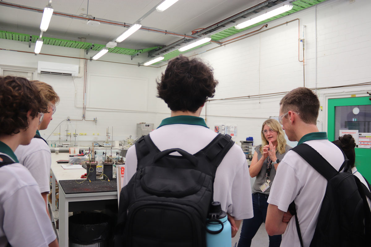 An Academic talks to students in a workshop / lab space