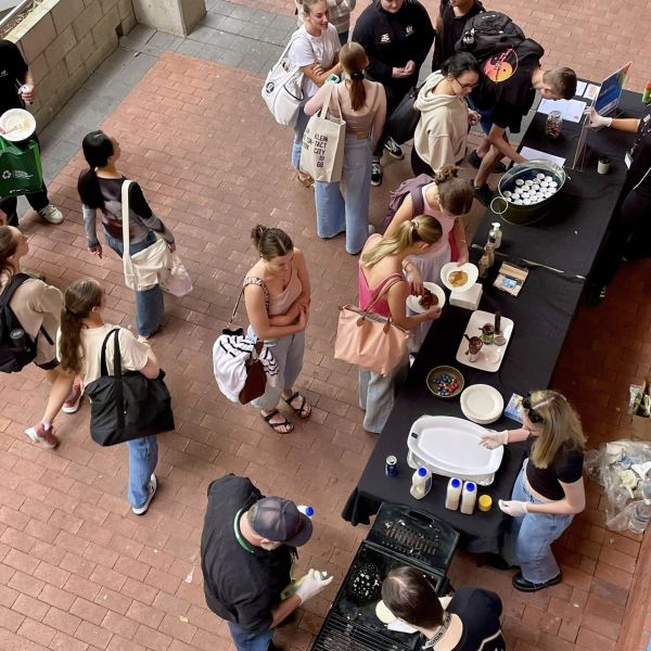 A group of students lining up for pancakes