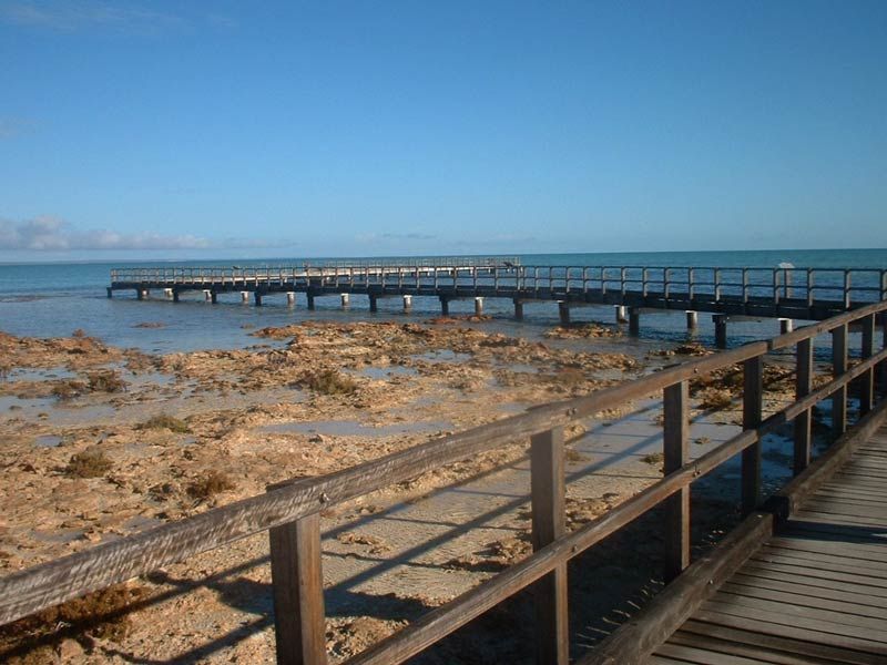 A rocky shark bay with a wharf
