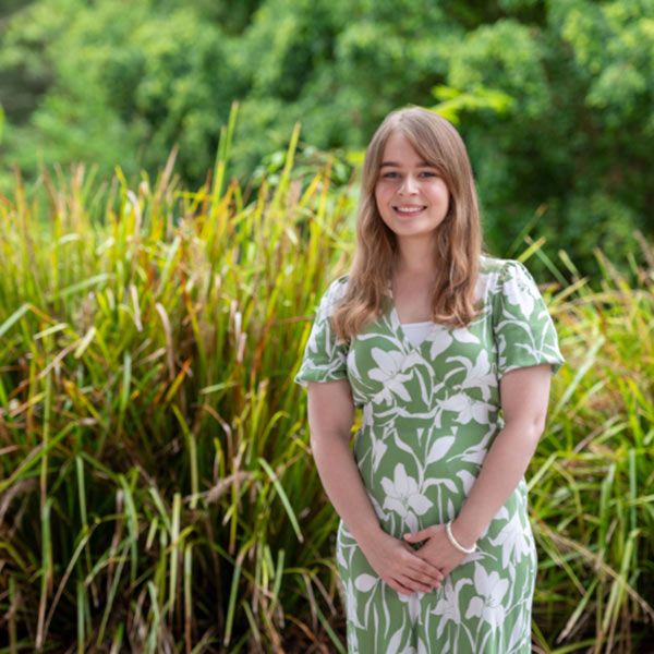 lady-standing-grass-field