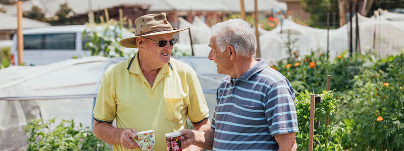 Men drinking coffee at a farmers market