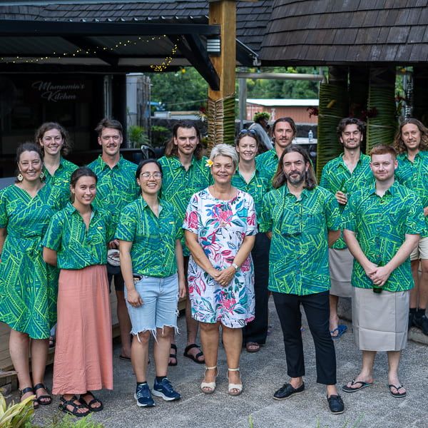 group shot of University of Newcastle staff and students wearing traditional Samoan clothing in a green pattern