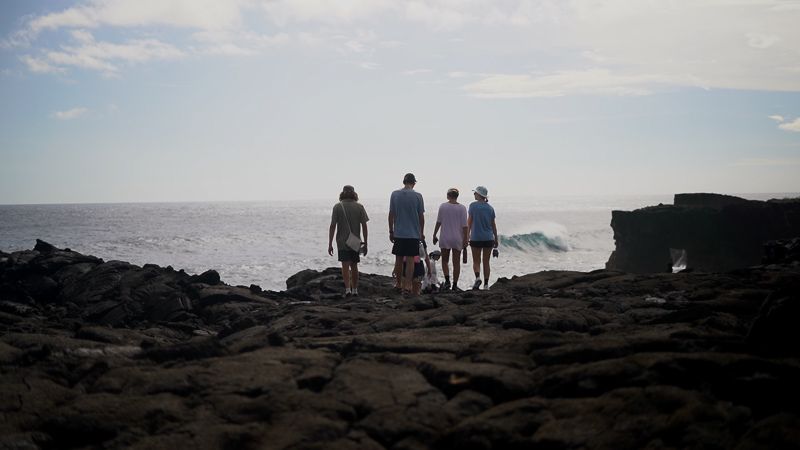a group of students admiring the vast coastline of Samoa 